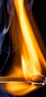 Lit matchstick with orange flames and gray smoke on a black background.