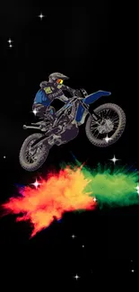 Motocross rider jumps with vibrant colors against starry night backdrop.