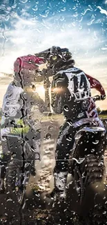 Two motocross riders in rainy sunset.