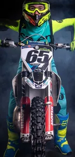 Motocross rider in vibrant gear on a smoky blue background, ready for action.