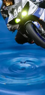 High-speed motorbike racing over blue water ripples wallpaper.