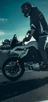 Rider on a motorcycle under a vibrant blue sky.