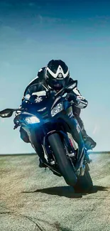 Motorcycle rider leaning on curve with blue sky background.