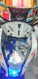 Motorcycle close-up with colorful helmet and dynamic front view.