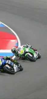 Two motorcycles racing on a track corner.