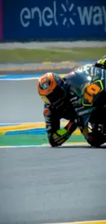 Motorcycle racer taking a sharp turn on track.