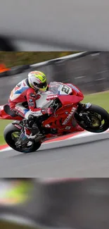 A professional motorcycle racer on a red bike in motion on a track.