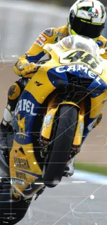 Motorcycle racer in action on vibrant track wallpaper.