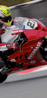 High-speed red motorcycle on race track in action wallpaper.