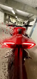 Dynamic red motorcycle in a garage setting.