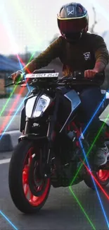 Person on a motorcycle with vibrant lights in the background.