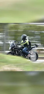 Motorcyclist in motion on open road with blurred background.