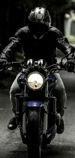 Motorcyclist riding on a dark road with a powerful presence.