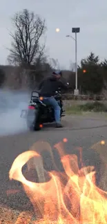 Motorcycle performing burnout with fiery background.