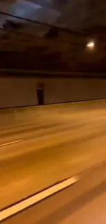 Motorcycle swiftly moving through an illuminated tunnel during nighttime.