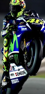 Motorcycle performing a high-speed wheelie at night.