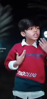 A young boy in a vibrant night backdrop.