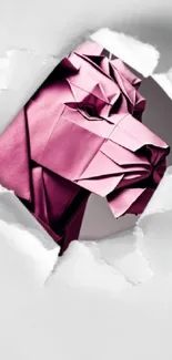 Pink origami lion emerging through torn paper on mobile wallpaper.