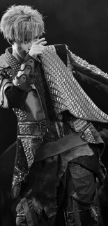 Monochrome image of a performer in detailed costume on stage.