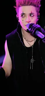 Dynamic performer with purple accents in black attire on stage.