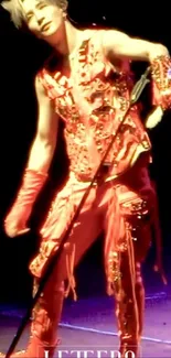 Performer in a vivid red outfit on stage, showcasing energetic presence.