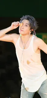 Energetic performer on stage with a beige tank top.