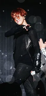 Performer in black outfit on stage in striking pose.