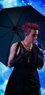 Performer with umbrella on a cosmic blue stage background.