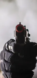 A gloved hand holding a pistol in high focus with a soft background.