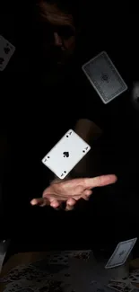 Floating playing cards captured in dramatic effect over a black backdrop.