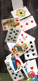 Dynamic mobile wallpaper featuring cascading playing cards over a dark wood background.