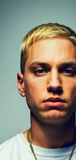 Portrait of a young man with blonde hair and intense gaze.