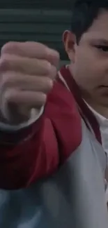 Young person with a red jacket showcasing a punch gesture.