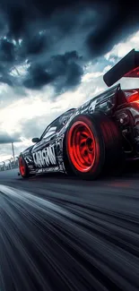 Vibrant racing car on a track under a dramatic sky.