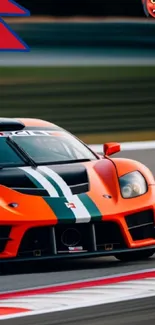 Dynamic orange race car on track wallpaper.