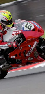 Red motorcycle racing on a track, showcasing speed and agility.