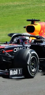 Red Bull Racing car speeding on track, black and red colors.