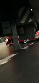 Red sports car racing under a bridge.