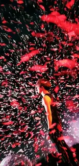 A person stands amidst a burst of red and black confetti, creating a dynamic visual.