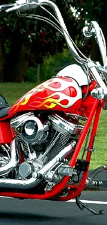 Red motorcycle with chrome accents parked on pavement.