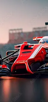 Red racing car on track at sunset.