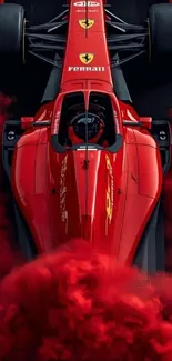 Red racing car surrounded by smoke, captivating motorsport scene.