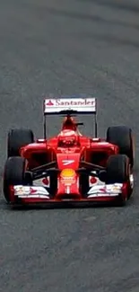 Dynamic red racing car on a track in vibrant motion.