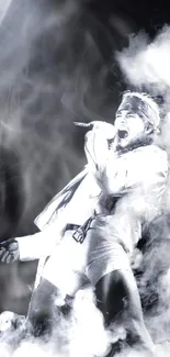 Rock star in smoke on stage, black and white wallpaper.