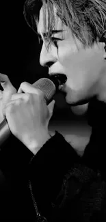 Black-and-white image of a singer performing passionately on stage.