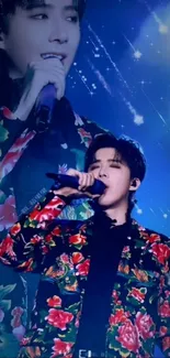 Singer in floral jacket performing with blue starry backdrop.