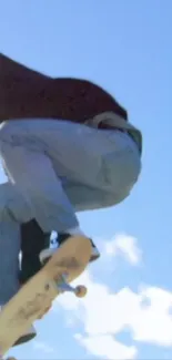 Skater performing an aerial trick against a blue sky.