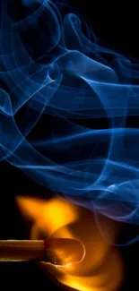 Blue smoke and orange flame on matchstick against black backdrop.