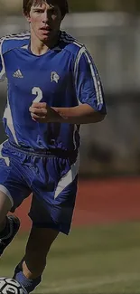 A soccer player in blue jersey running with a ball on the field.