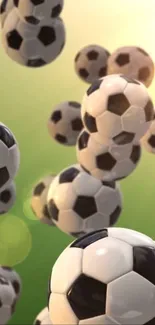 Soccer balls floating on green background wallpaper.